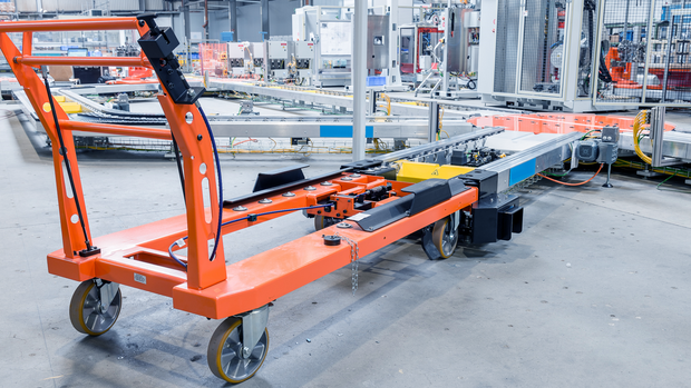 Transport system with a feed via a trolley